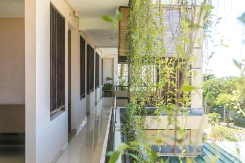 a hallway with plants on the side of a building at Rantun's Place Nusa Dua in Nusa Dua