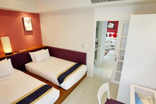 Кровать или кровати в номере The Beach Boutique House