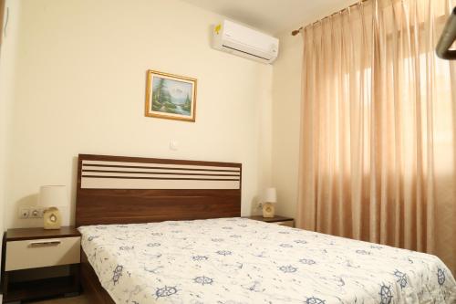 a bedroom with a bed and a window at SeaSide II family appartment in Keramotí