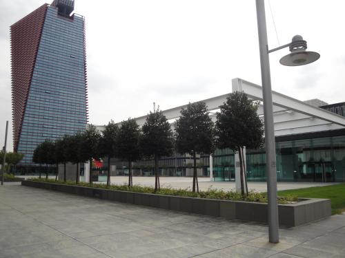 a building with a row of trees in front of it at Best Western Plus Net Tower Hotel Padova in Padova