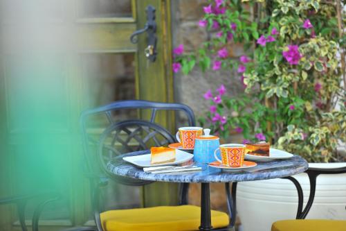 a table with plates of food and coffee cups on it at Petrino Gökçeada Hotel&Kitchen in Gokceada Town