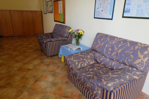 a living room with a couch and a chair at Hostel il Tetto in Melfi