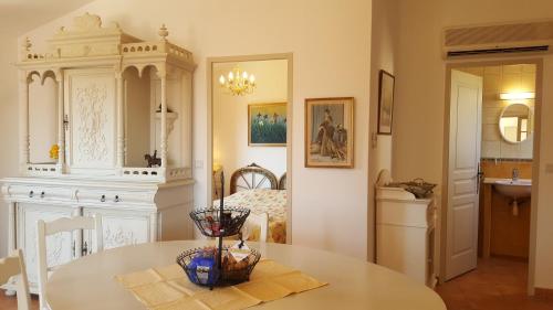 a living room with a table and a bedroom at Résidence A Merula in Calvi
