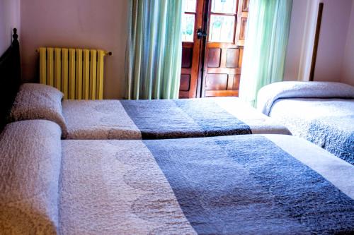 a bedroom with a bed and a television at Hotel Los Angeles in Santillana del Mar