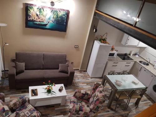 a living room with a couch and tables at Apartamentos Santa Justa in Ubiarco