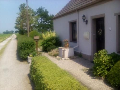 a white house with a fire hydrant in the yard at up de Pfahldeichsweg in Neugarmssiel