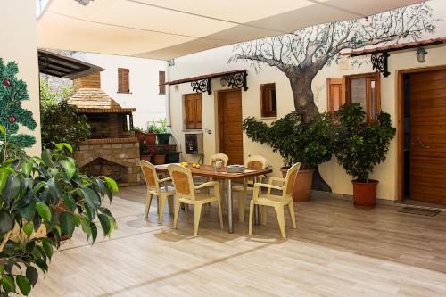 a dining room table and chairs on a patio at Alkyoni Apartments in Agios Nikolaos