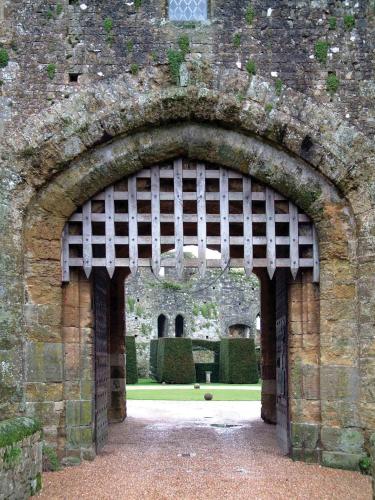 an archway in a stone building with a courtyard at Amberley Castle- A Relais & Chateaux Hotel in Amberley