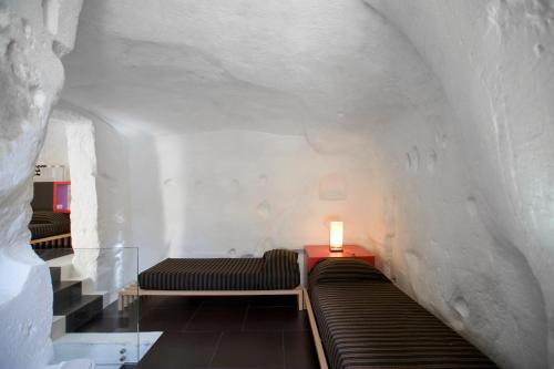 Un ou plusieurs lits dans un hébergement de l'établissement Basiliani Hotel