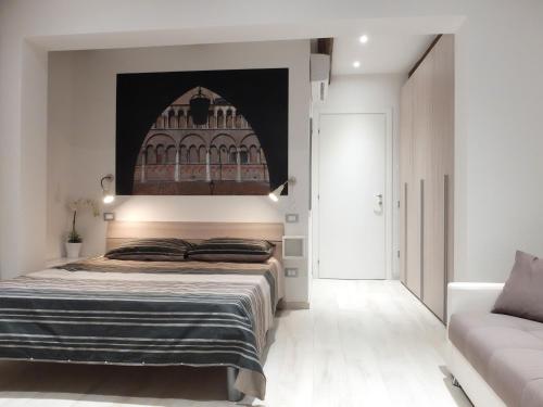 a bedroom with a bed and a couch at Centro Storico Rooms in Ferrara