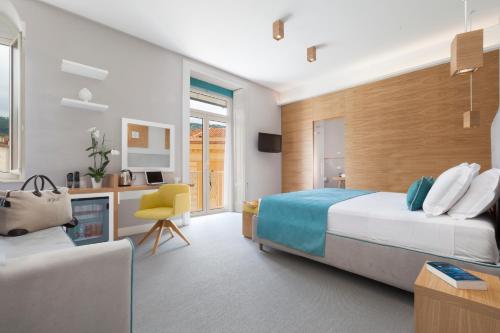 A bed or beds in a room at La Piazzetta Guest House