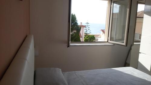 a room with a couch and a window with a view at ele&gio accomodation in Tropea