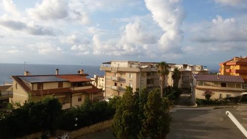 a view of a city with buildings and the ocean at ele&gio accomodation in Tropea
