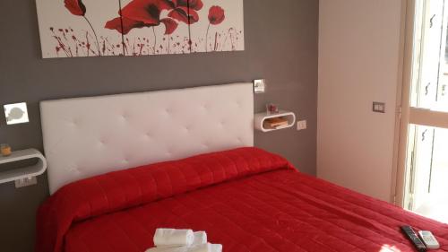 a bedroom with a red bed with a red blanket at ele&gio accomodation in Tropea