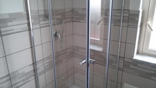 a shower with a glass door in a bathroom at ele&gio accomodation in Tropea