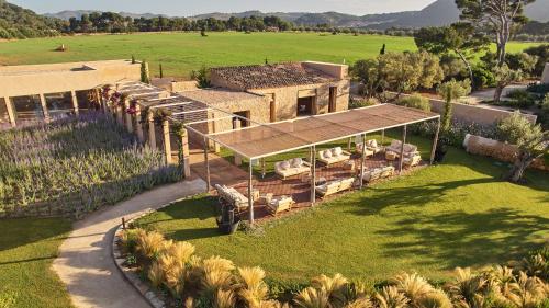 an aerial view of a house with sheep in a field at Pleta de Mar, Grand Luxury Hotel by Nature - Adults Only in Canyamel