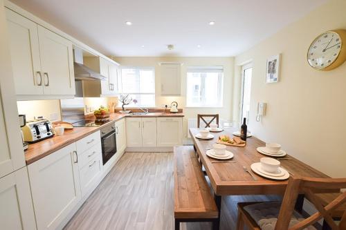 a kitchen with a wooden table and a wooden counter top at Hillyard Mews in Newcastle