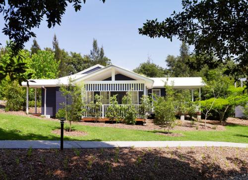 a house with a garden in front of it at Bells at Killcare Boutique Hotel, Restaurant & Spa in Killcare