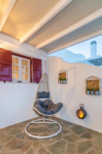a hammock chair in the corner of a room at Fouli's House at "Porto Vlastos" in Agios Ioannis Tinos