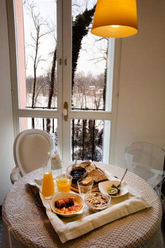 a table with a tray of breakfast food on it at Agriturismo Cascina Caremma in Besate