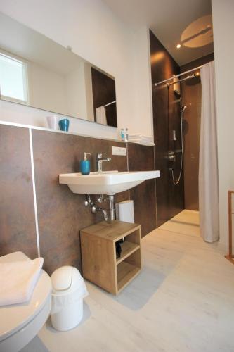 a bathroom with a sink and a toilet at Aparthotel Gartenstadt in Bamberg