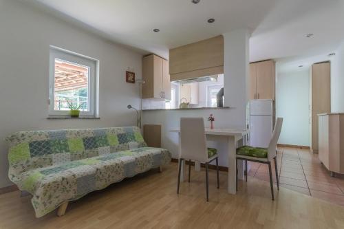 a living room and kitchen with a couch and a table at Holiday Home Neokrnjena Narava in Sevnica