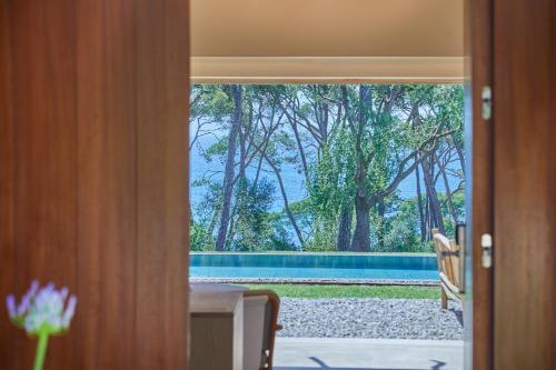 a door to a room with a view of a pool at Pleta de Mar, Grand Luxury Hotel by Nature - Adults Only in Canyamel