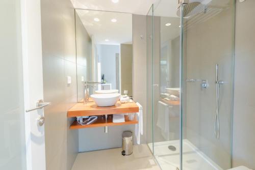 a bathroom with a glass shower and a sink at Torre de Tebra in Tomiño