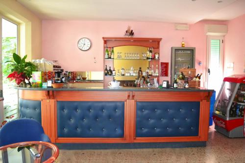 a bar in a restaurant with a pink wall at Hotel Ivana in Bellaria-Igea Marina