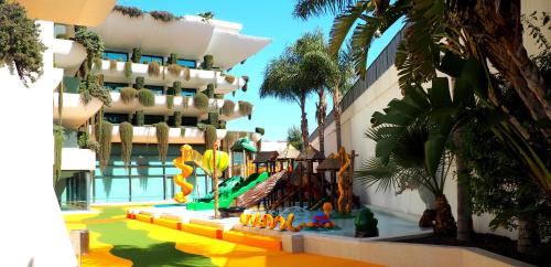a building with a water park in front of it at Hotel Deloix 4* Sup in Benidorm