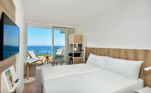 a bedroom with a bed and a view of the ocean at INNSiDE by Meliá Calviá Beach in Magaluf