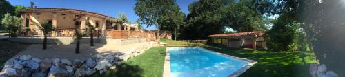 a house with a swimming pool next to a building at Guesthouse Le Pujol in Sainte-Foy-dʼAigrefeuille
