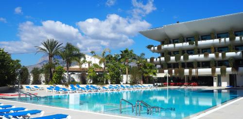 a swimming pool in front of a hotel at Hotel Deloix 4* Sup in Benidorm