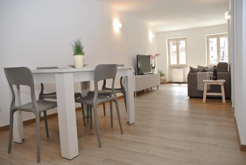a white dining room table and chairs in a living room at Casa del Borgo Maria Luisa by Gardadomusmea in Tremosine Sul Garda