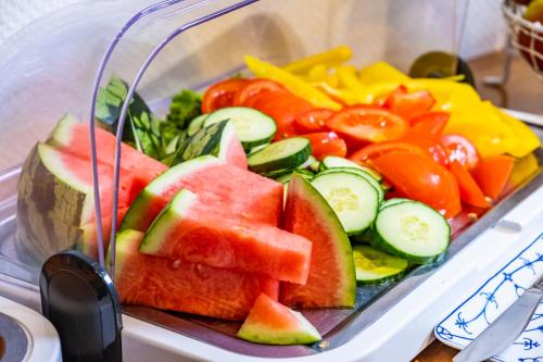 a plastic tray filled with fruits and vegetables at Hotel, Restaurant, Café Pharisäerhof - Nordseeurlaub mit Hund in Nordstrand