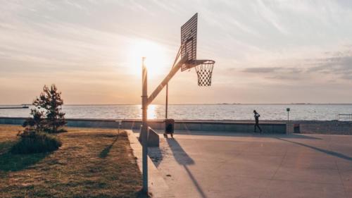 a basketball hoop on the beach at sunset at The Beach apartments by Daniel&Jacob's in Copenhagen