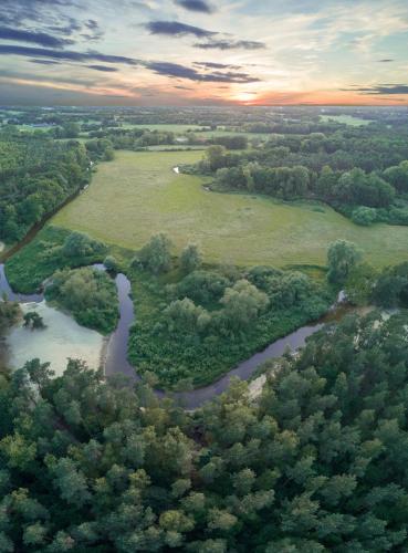 an aerial view of a river with trees at Van der Valk Theaterhotel Almelo in Almelo