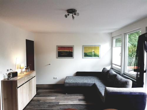 a living room with a couch and a table at Ferienhaus am Badesee Schönsee Bungalow 12 in Urnshausen