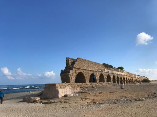 an old stone bridge on the beach at Apartment Caesarea 38 in Caesarea