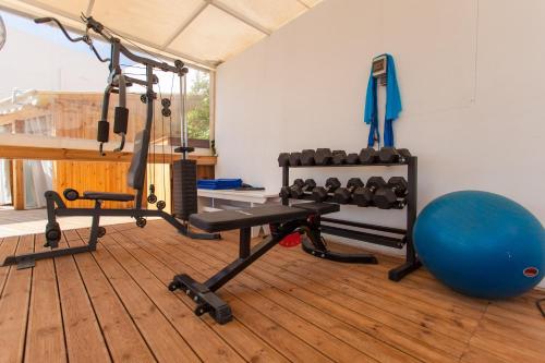 a gym with a bench and a gym ball at Georgioupolis Beach Hotel in Georgioupolis