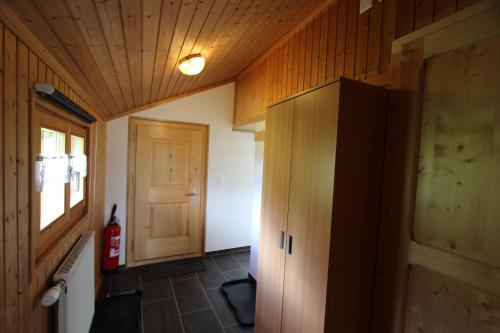 a room with a hallway with a door and a room with a fire hydrant at Les Mourriaux in Chateau-d'Oex