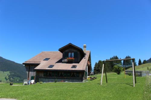 a house on a hill with a soccer goal at Les Mourriaux in Chateau-d'Oex