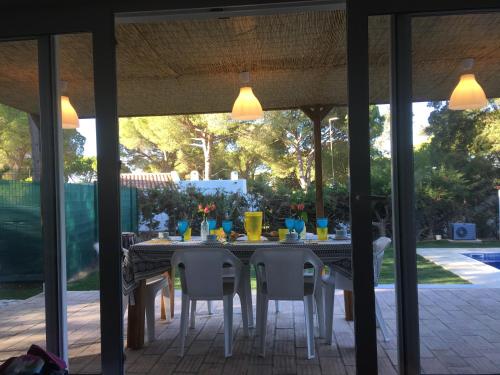 a dining table and chairs on a patio at Villa Zen - beautiful private pool-heating option, hot tub, beautiful garden in Albufeira