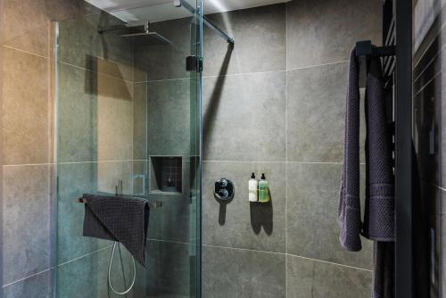 a bathroom with a shower with a glass door at The Sawley Arms in Ripon