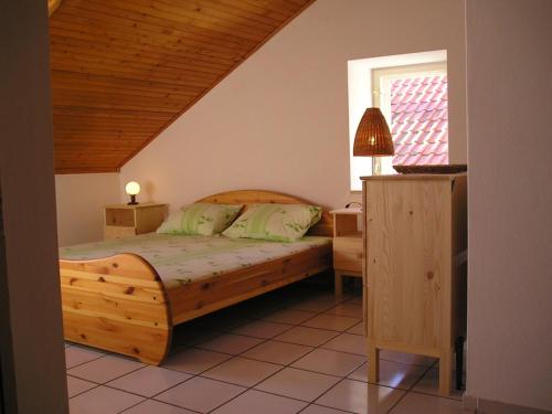 a bedroom with a wooden bed and a window at Apartments Pavla in Orebić
