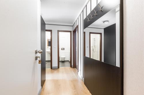 a hallway leading to a bathroom with black and white walls at Hotel Mandát in Hradištko