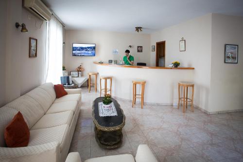 a living room with a couch and a bar at Likio Studios in Batsi