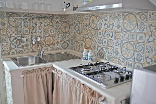 a kitchen with a stove and a sink at La Buona Creanza by Jdvacanze in Manduria
