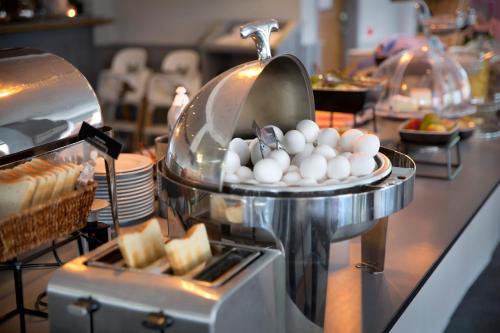 a buffet with eggs and bread on a table at First Hotel Dragonen in Umeå