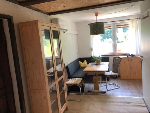 a living room with a table and a couch at Ferienhaus-Elisabeth Bungalow-Tom Bungalow-Peter in Reinhardtsdorf